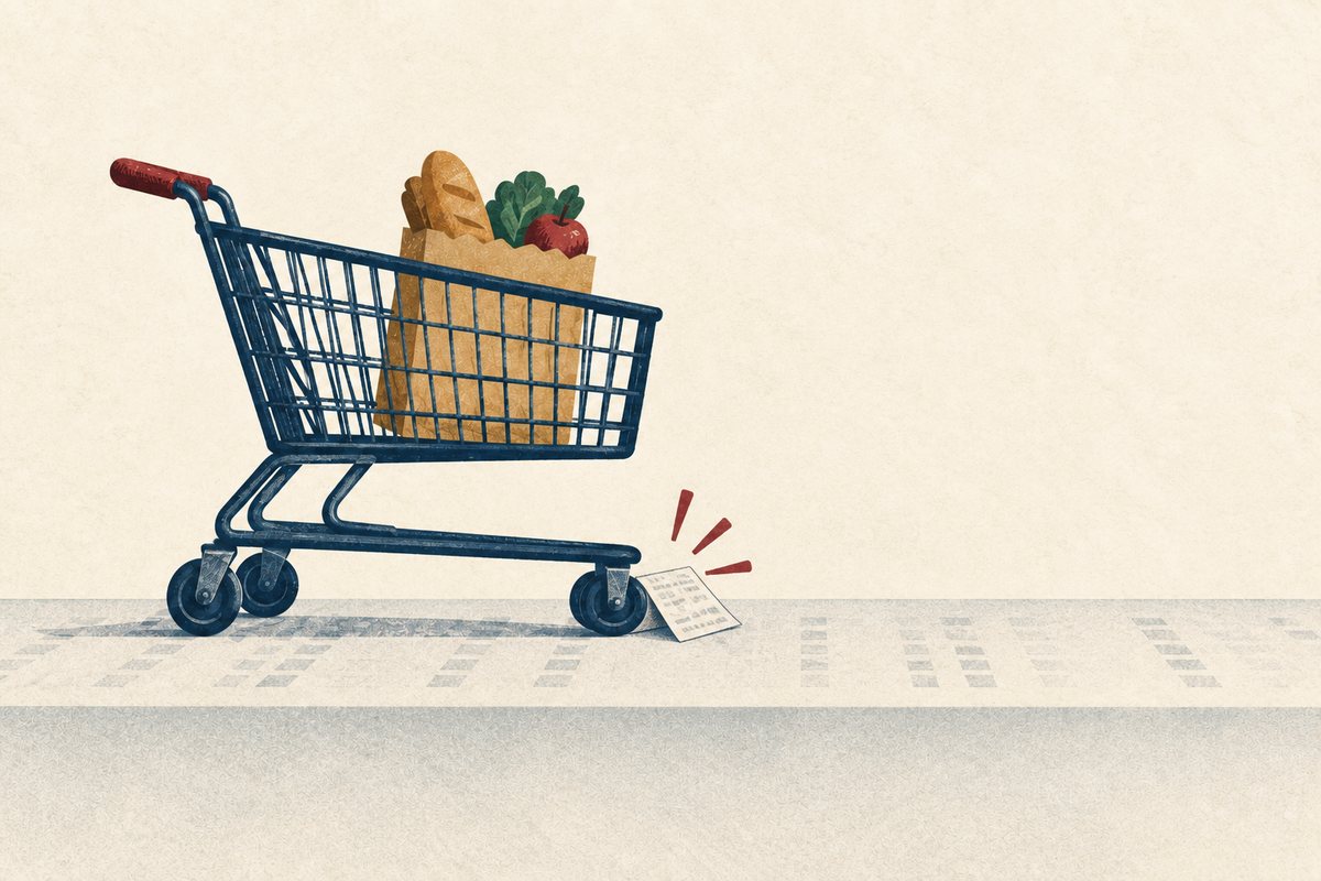 A grocery trolley pauses at a small folded receipt placed against its front wheel.