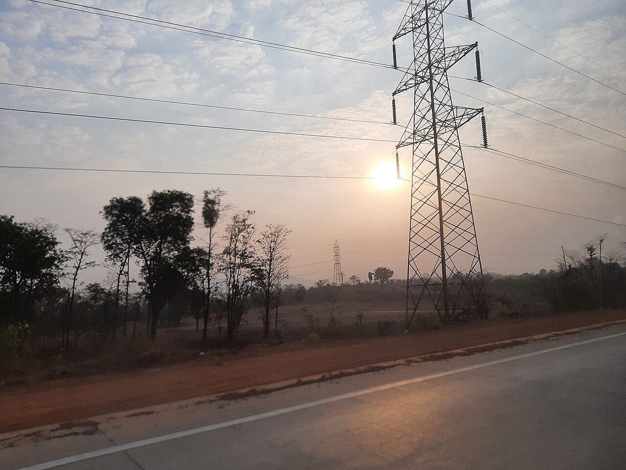 Electricity transmission tower and overhead lines; illustrative photograph, not Nscale's Loughton site or a Microsoft facility.